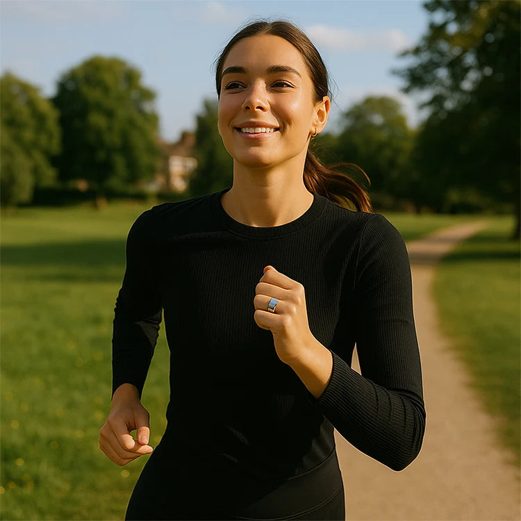 Woman running outdoors with calmara ring on a path with greenery in the background