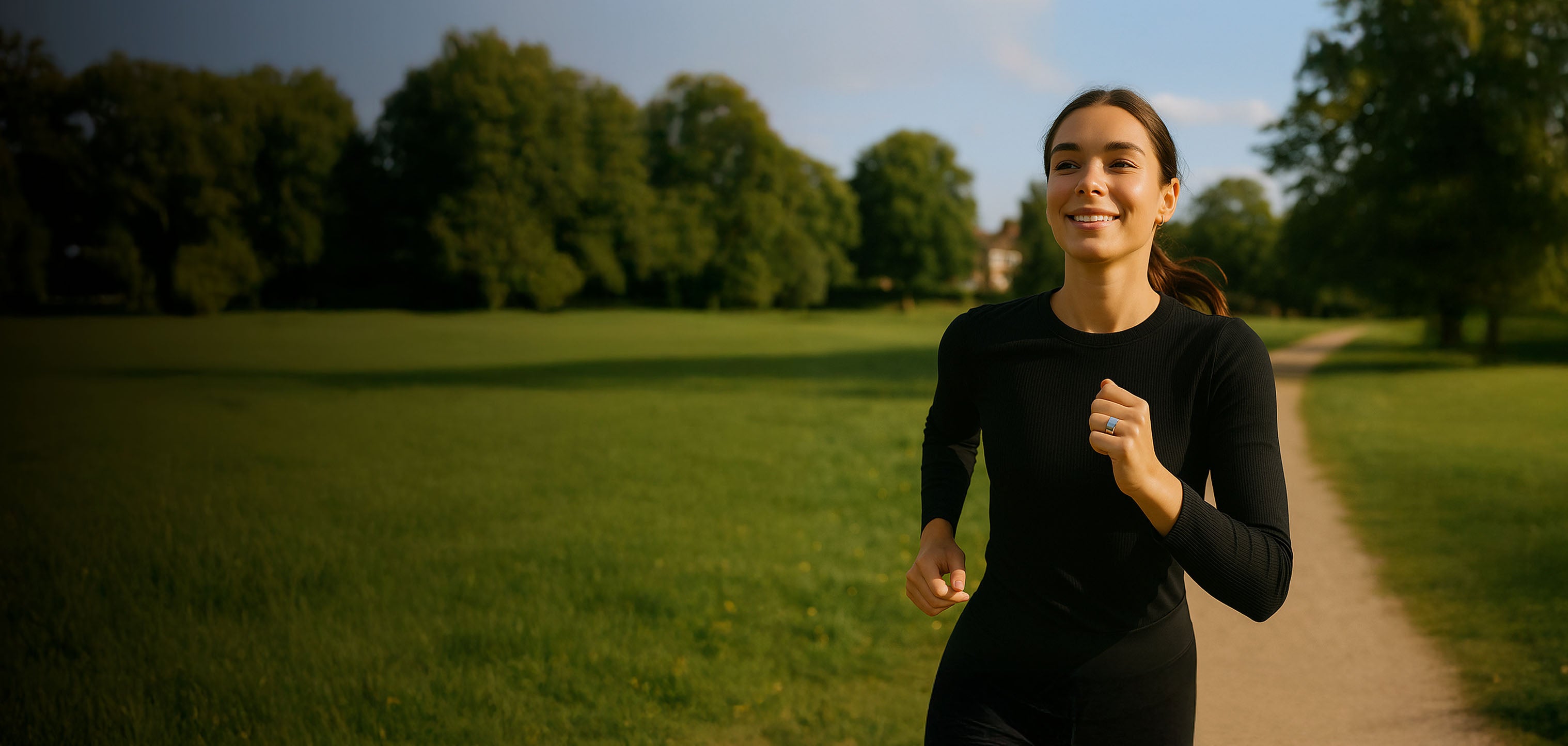 Woman running on a path in a park with trees in the background